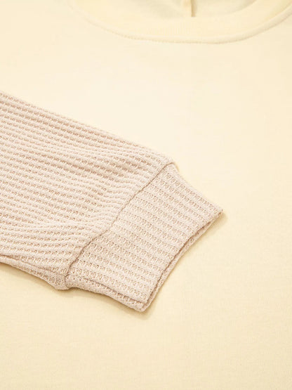 Health Hive beige faux two-piece patchwork sweatshirt with a textured waffle knit sleeve and ribbed cuff detail.