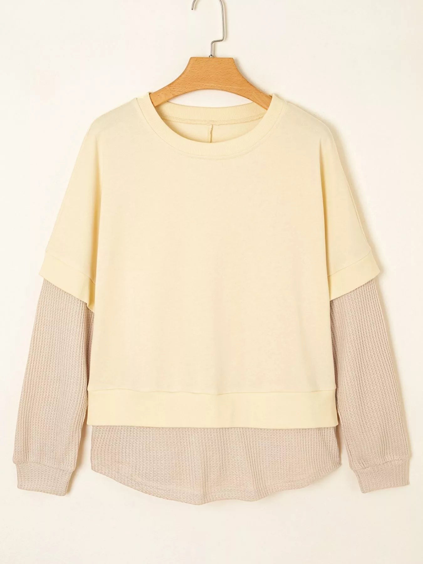 Health Hive cream and beige 2-in-1 faux two-piece patchwork sweatshirt with a round neck and waffle knit sleeves.