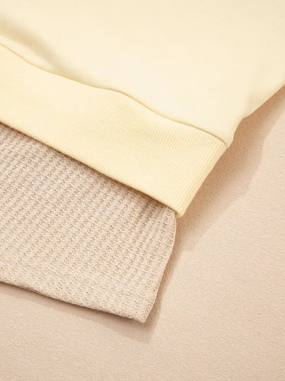 Health Hive 2 in 1 faux two-piece sweatshirt featuring a smooth pale yellow top layer over a textured beige waffle knit.