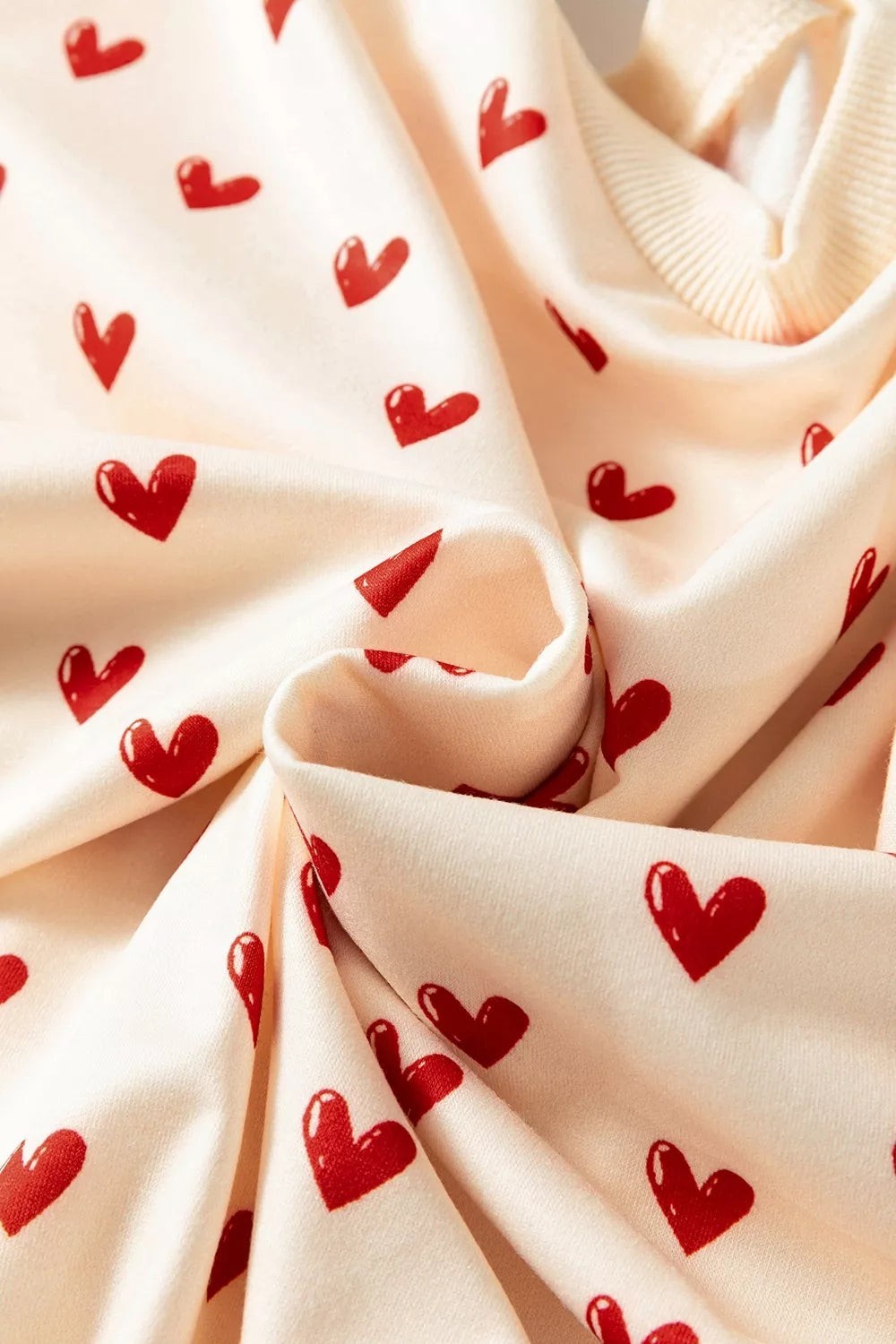 Health Hive cream sweatshirt with a red heart print pattern and ribbed round neckline in soft polyester fabric