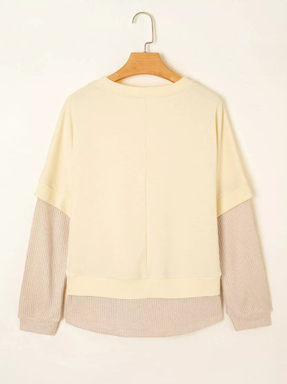 Health Hive 2-in-1 faux two-piece patchwork sweatshirt in cream and beige with a round neck and long sleeves.